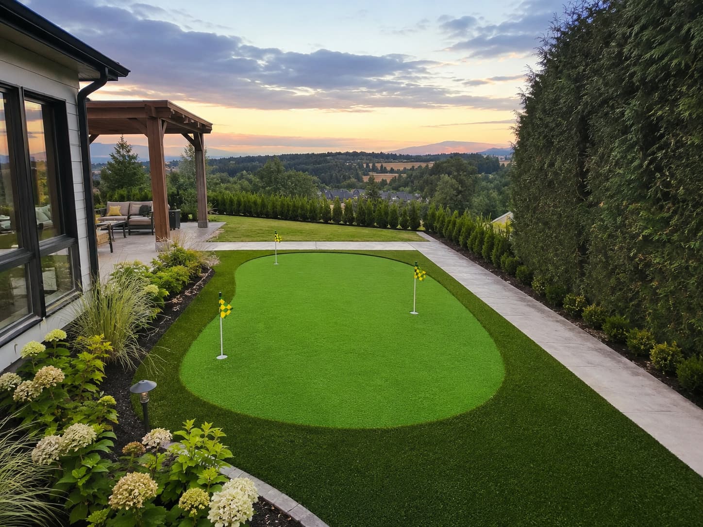 Finished backyard putting green with cups, flags and people playing